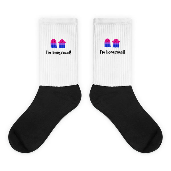 Pair of black-and-white socks with pink-blue ghosts and “I'm boosexual!” text