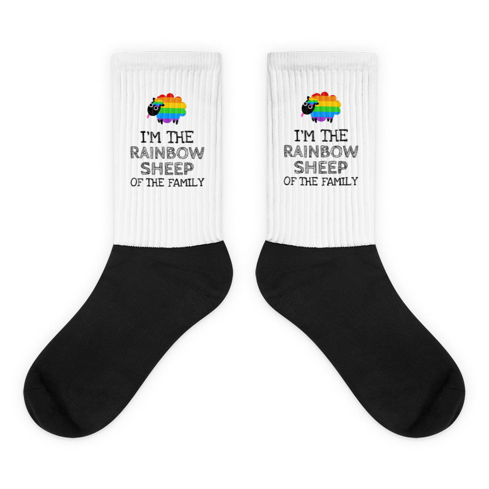 Pair of black-and-white socks with rainbow sheep and “I’M THE RAINBOW SHEEP OF THE FAMILY” text