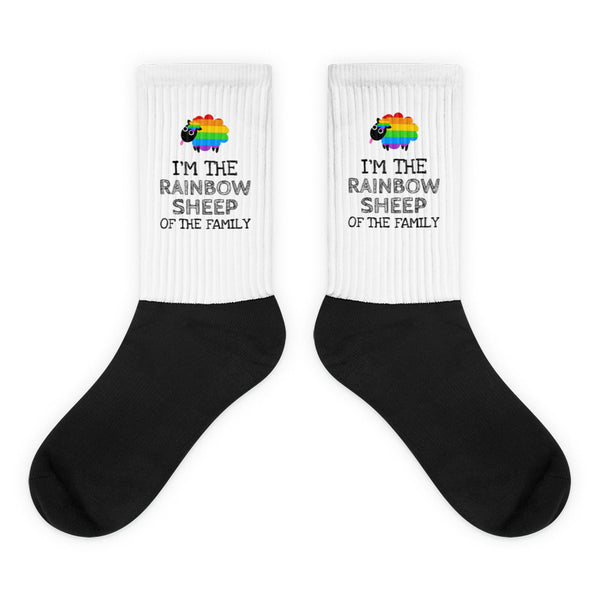I'm The Rainbow Sheep Of The Family Socks feature black feet and white cuffs with rainbow-striped sheep and slogan, celebrating queer pride with bold, comfortable, and stylish self-expression.