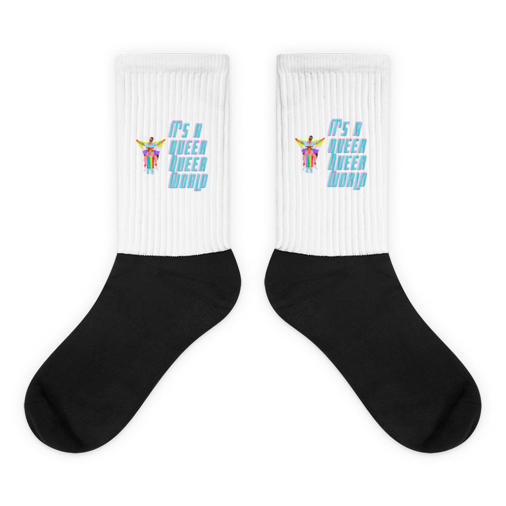 Pair of white ribbed socks with black feet and colorful “It’s a Queer Queer World” graphics