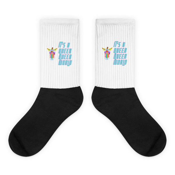 It's A Queer Queer World Socks feature bold black feet, cushioned soles, and white ribbed legs with rainbow graphics, celebrating queer pride and self-expression with comfort and vibrant visibility.