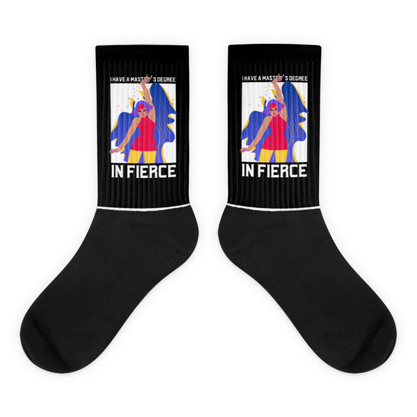Master's Degree In Fierce Socks: Black crew-length socks featuring a bold illustration of a fierce woman with colorful attire, embodying vibrant queer pride and empowerment. Perfect for celebrating self-expression and visibility.
