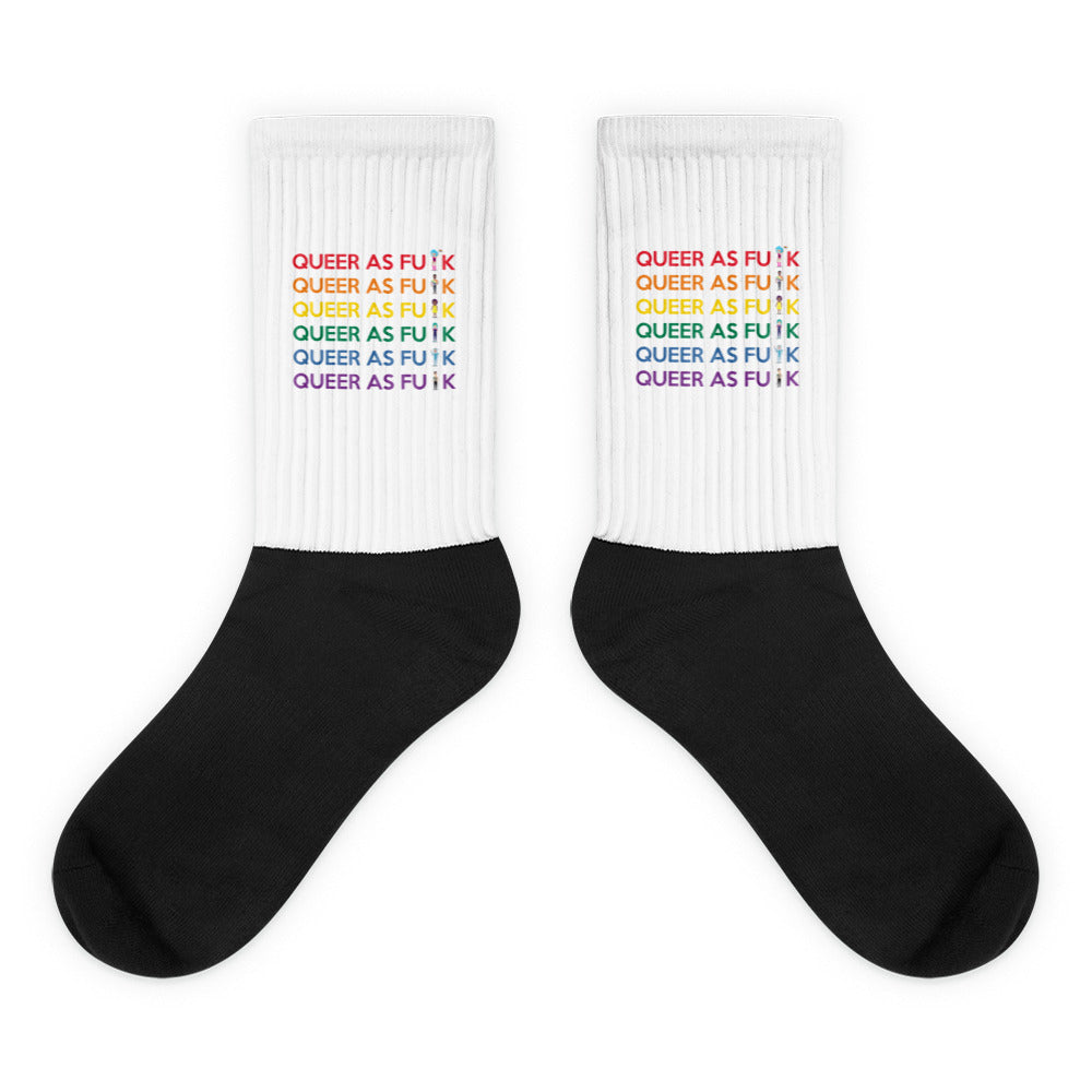 Pair of black-and-white statement socks; queer Pride socks with “Queer As F#CK” design