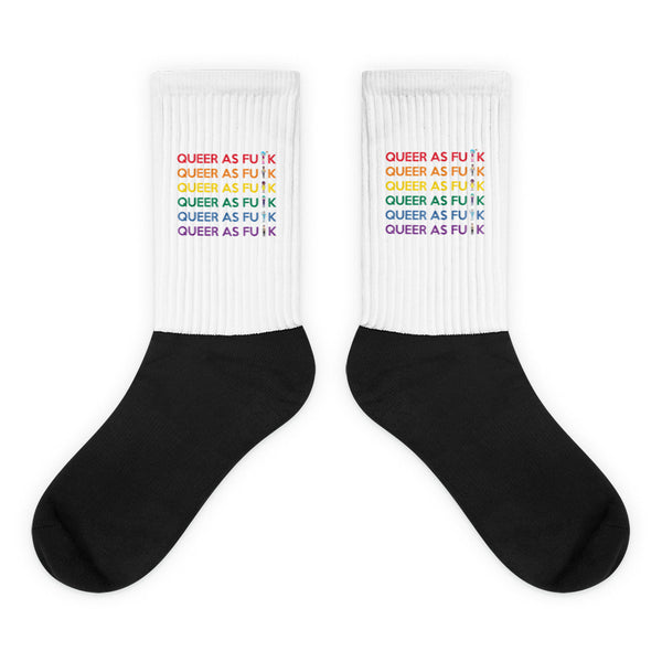 Queer As Fu#k Socks: Bold black foot, rainbow-lettered white leg celebrating pride and self-expression. Crafted for comfort and style, embodying queer empowerment with every step.