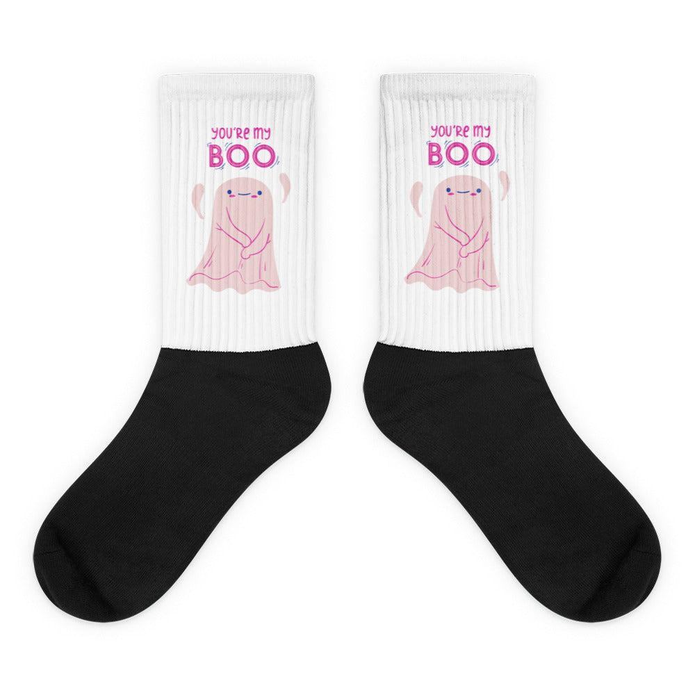 Pair of white-and-black socks with pink ghosts and “YOU’RE MY BOO” text