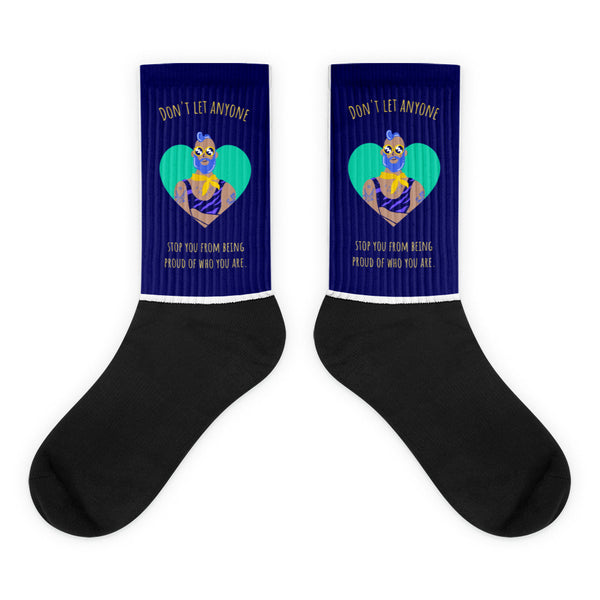 Don't Let Anyone Stop You From Being Proud Socks feature a black foot, dark blue leg with a mint-green heart graphic, and empowering gold text, celebrating pride and self-expression with vibrant, inclusive style.