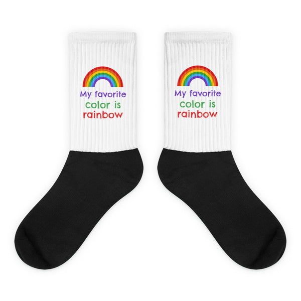 My Favourite Color Is Rainbow Socks feature a striking black foot and white leg with vibrant rainbow graphics and the empowering phrase, embodying bold queer self-expression and prideful comfort.