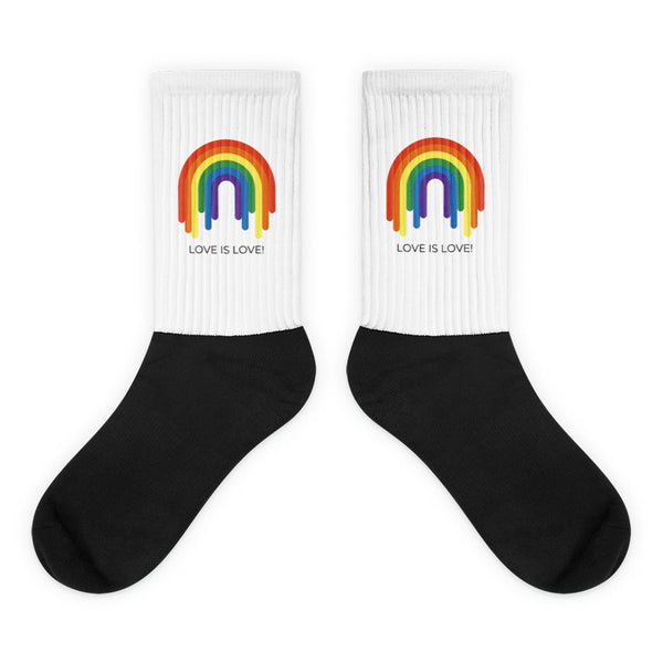 Love Is Love Rainbow Socks: Crew-length socks with a black foot and heel, white ribbed leg featuring a dripping rainbow and LOVE IS LOVE! graphic. Embrace pride with comfort and vibrant self-expression.
