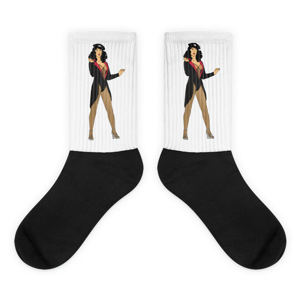 Cher Burlesque Socks feature a striking pin-up illustration on a white calf with a solid black foot. Crafted from a nylon-cotton-spandex blend, they embody bold queer expression and vibrant self-expression.