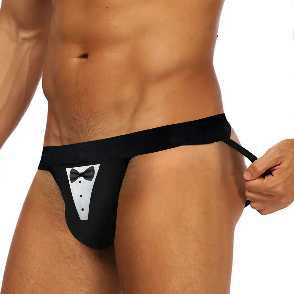 Front view of a person wearing a black thong with a tuxedo bib and bow tie print