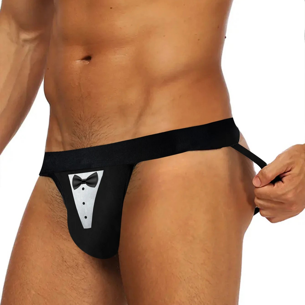 Front view of a person wearing a black thong with a tuxedo bib and bow tie print
