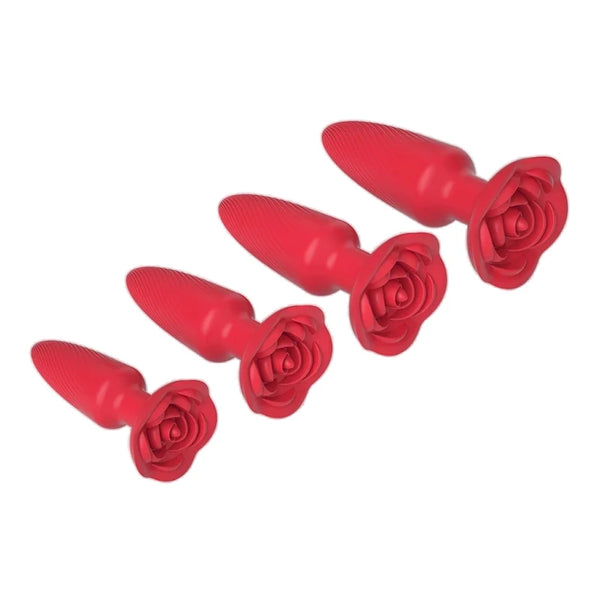 Four red silicone anal plugs arranged diagonally, each with a rose-shaped base