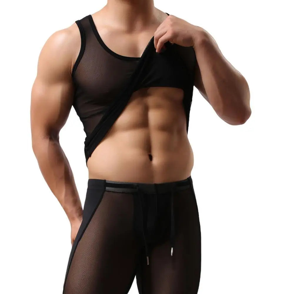 Front view of a muscular model lifting a sheer black mesh vest to expose the torso