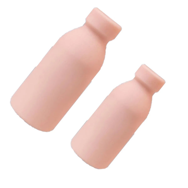 Two peach-colored bottle-shaped masturbators angled diagonally on a white background