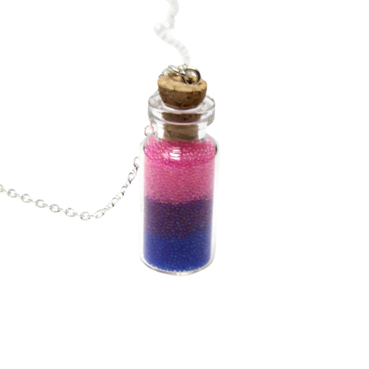 Close-up of a corked glass vial necklace filled with pink and blue beads