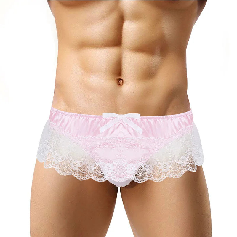 Front view of a model wearing pink lace-trimmed briefs with a white bow