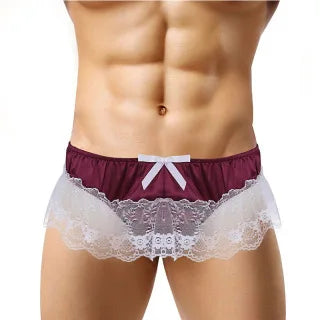 Front view of a model wearing burgundy briefs with a white bow and sheer lace trim