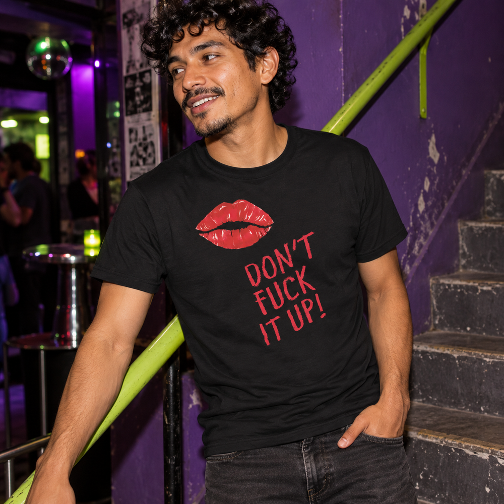 Don't Fuck It Up! T-Shirt in Black, worn at a violet-painted staircase with a narrow lime handrail.