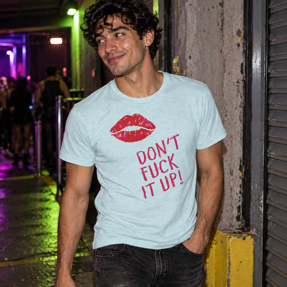 Don't Fuck It Up! T-Shirt in Heather Prism Ice Blue, worn at a concrete loading-bay entrance after a queer club night.