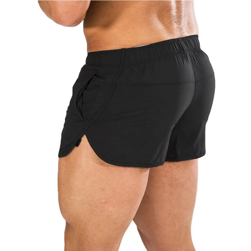 Rear three-quarter view of a model wearing black split-side athletic shorts