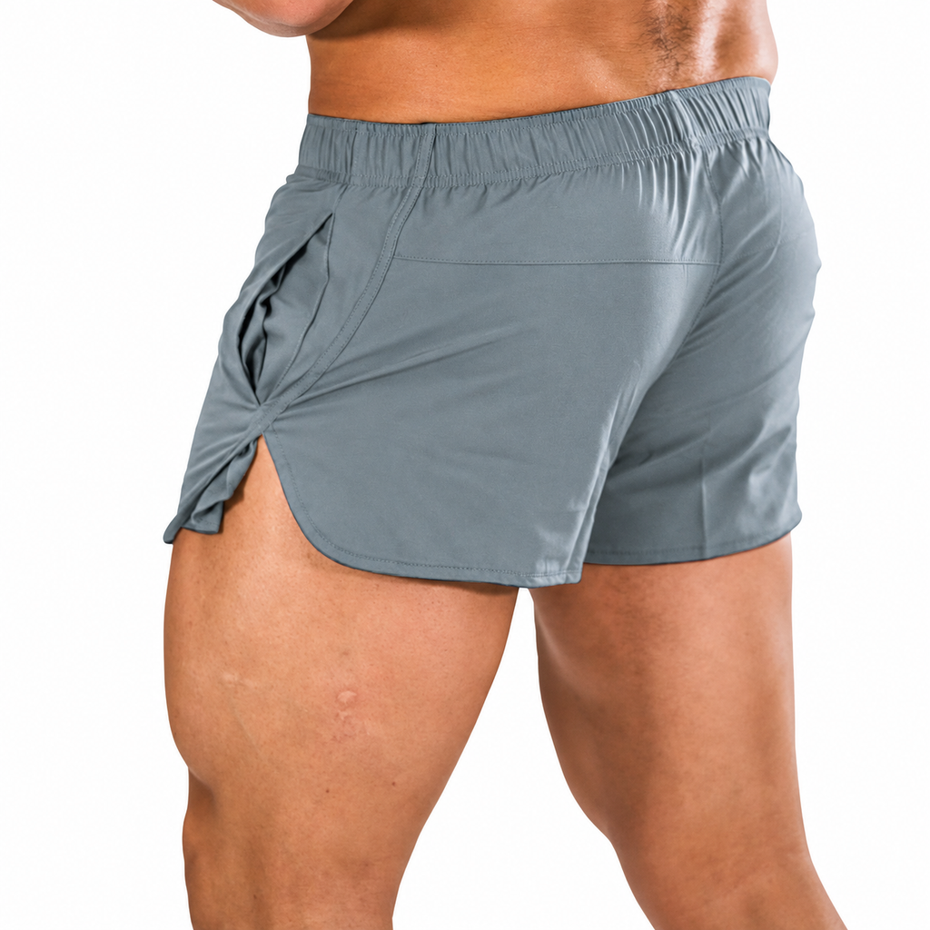 Front close-up of a person wearing gray gym shorts with a side split and pockets