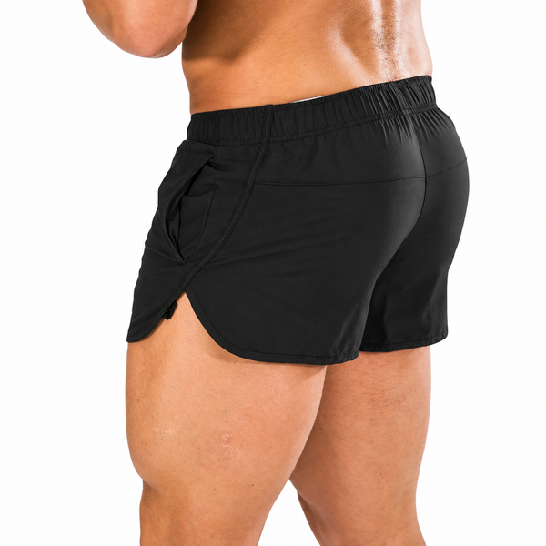 Rear three-quarter view of a model wearing black split-side athletic shorts