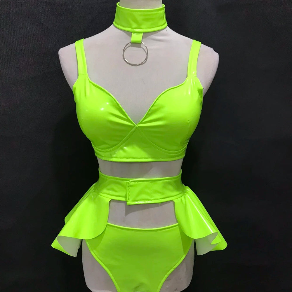 Front-view mannequin wearing a neon green vinyl bikini set with choker and hip cutouts