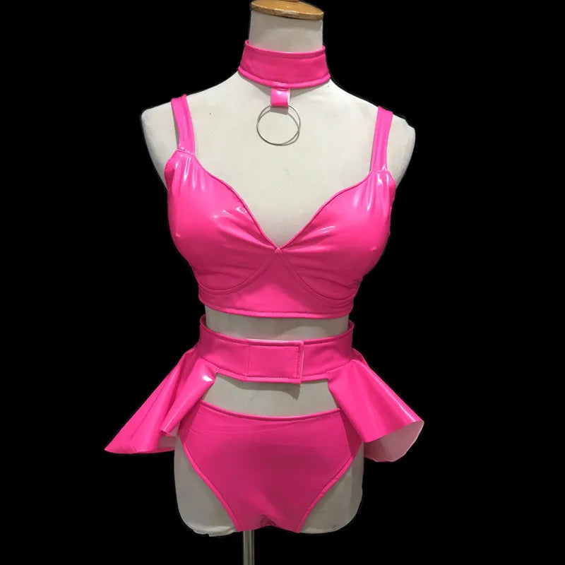 Front-view mannequin wearing a hot-pink vinyl bikini set with choker and hip ruffles