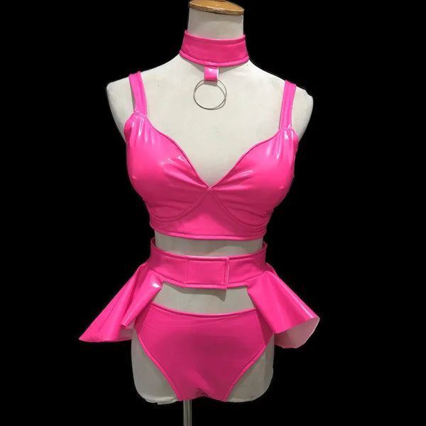 Front-view mannequin wearing a hot-pink vinyl bikini set with choker and hip ruffles