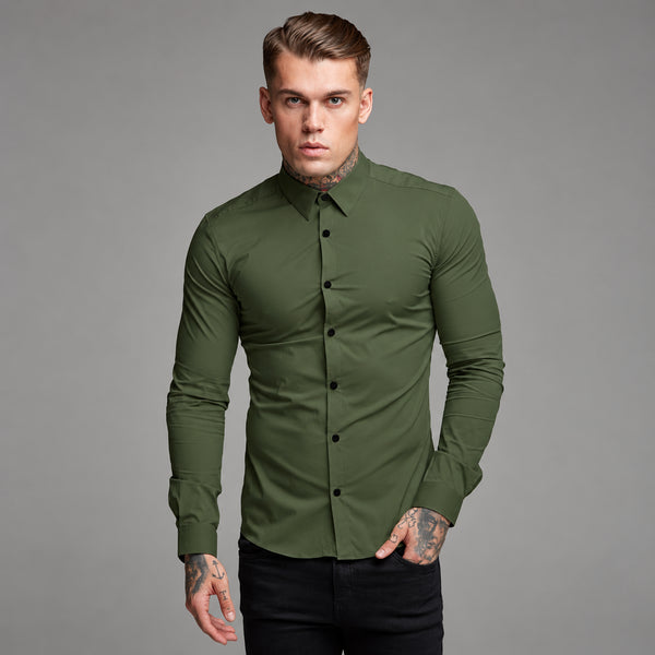 Front-facing model wearing a fitted olive-green long-sleeve button-up shirt