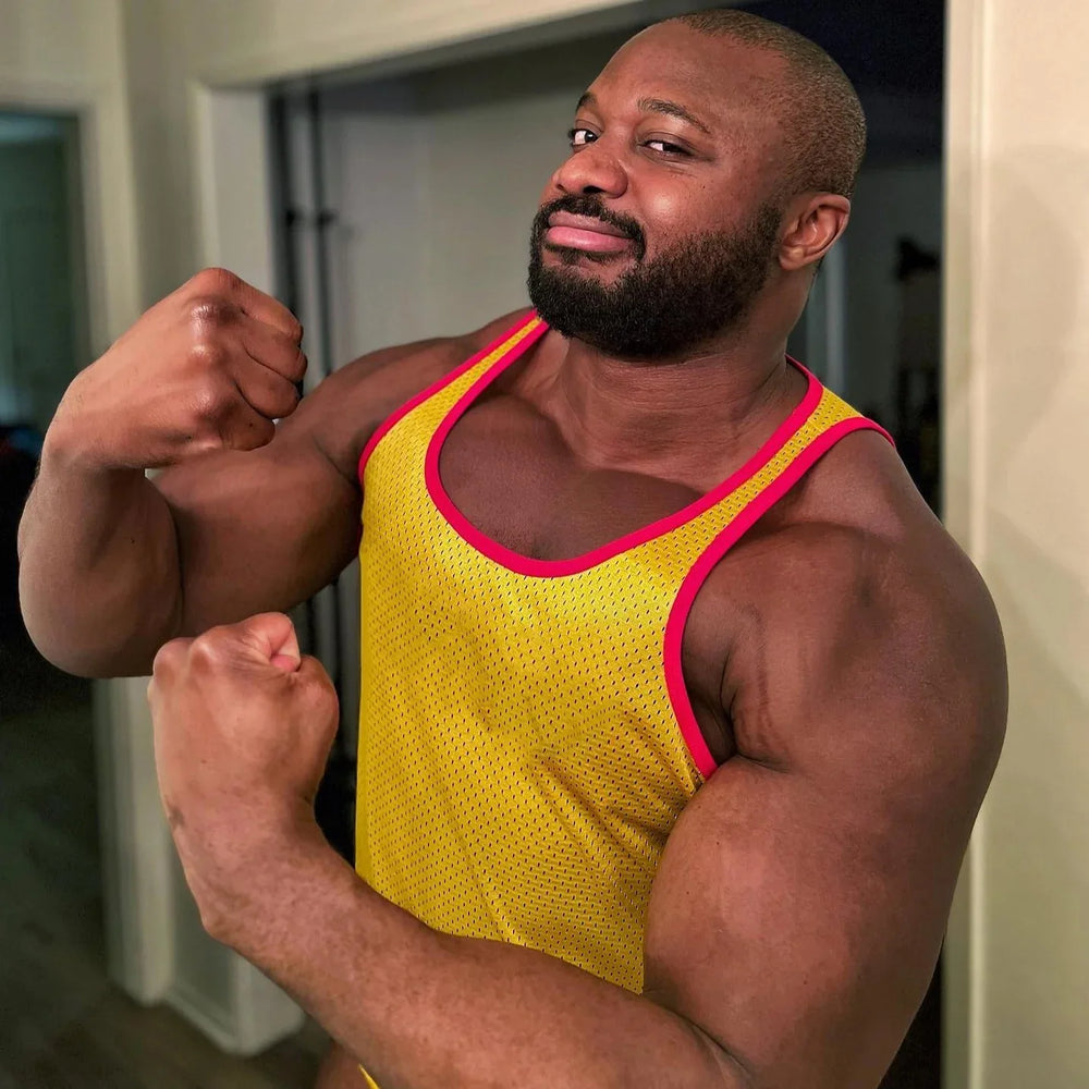 Person flexing in a yellow mesh athletic tank with hot-pink trim