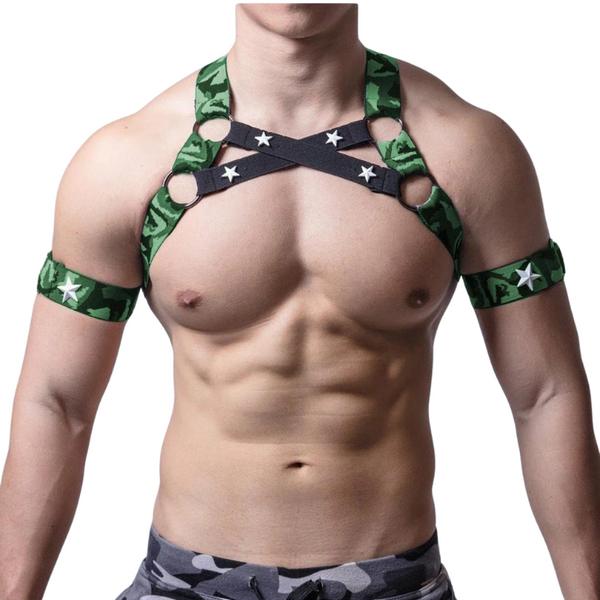 Front-view muscular model wearing a green camouflage chest harness and matching armbands