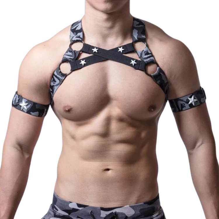 Front view of a shirtless model wearing a gray camouflage chest harness and matching arm bands
