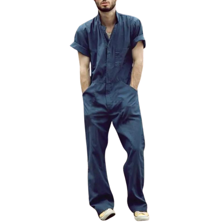 Front-facing person wearing a dark navy short-sleeve jumpsuit with hands in pockets and sneakers
