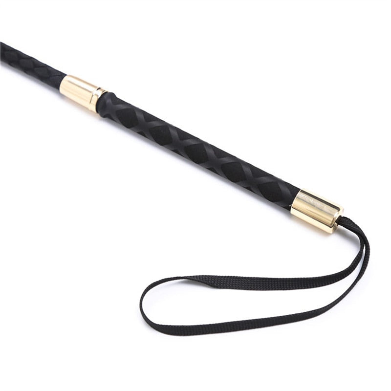 Black braided impact crop with gold-tone fittings and wrist loop on white
