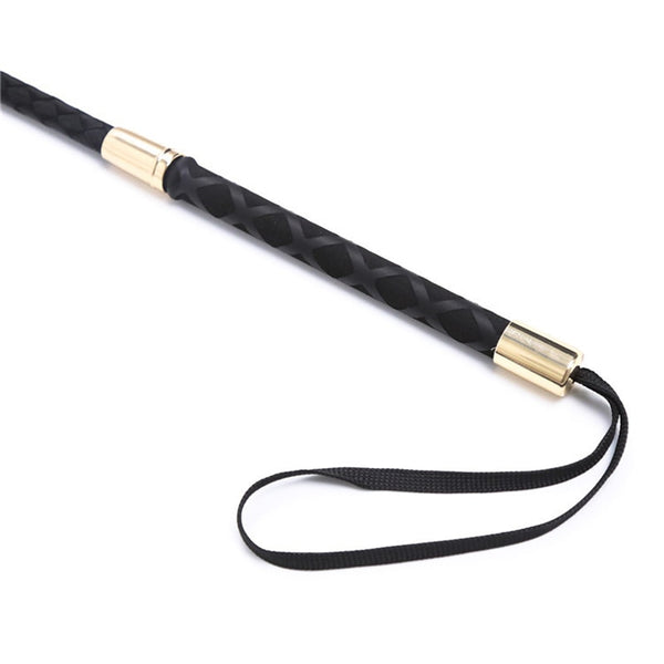 Black braided impact crop with gold-tone fittings and wrist loop on white