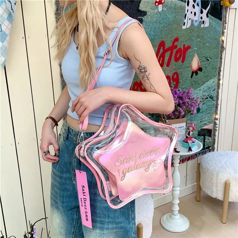 Model wearing a clear pink-trimmed backpack with a pink pouch reading “Soft deer in galaxy”
