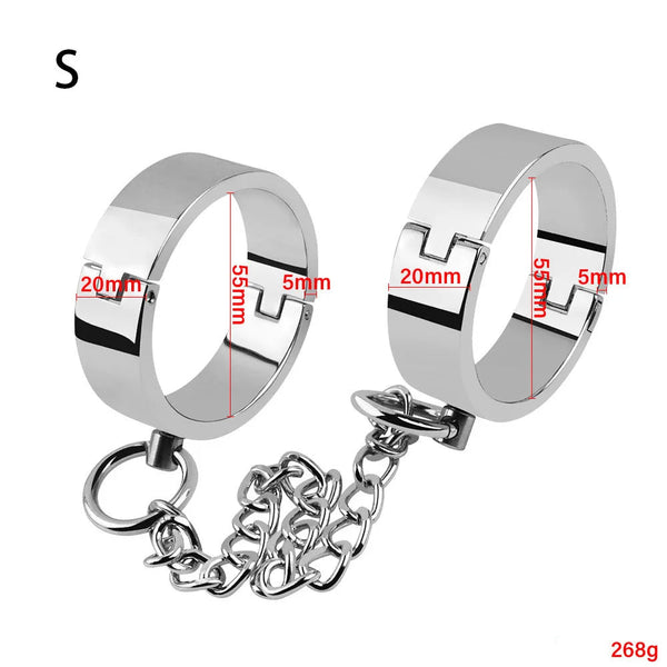 Pair of silver metallic bondage cuffs linked by a chain, shown with size markings