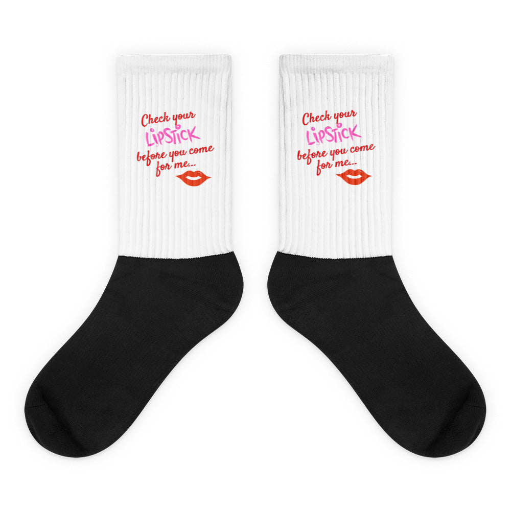 Pair of black-and-white socks reading “Check your LipStick before you come for me...”