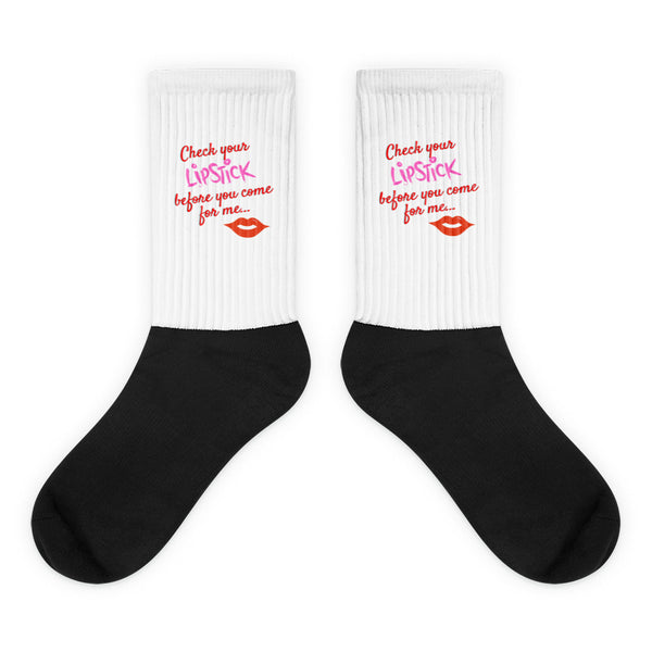 Pair of black-and-white socks reading “Check your LipStick before you come for me...”