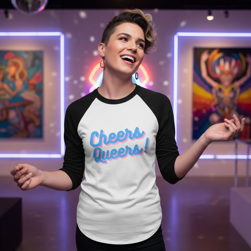 Cheers Queers! 3/4 sleeve raglan tee on a smiling person, hoop earrings, in a bold gallery of vibrant queer art and lights