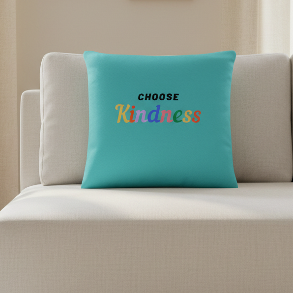 Choose Kindness pillow with bright rainbow lettering on turquoise fabric