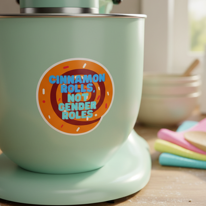 A pastel green stand mixer sports a “Cinnamon Rolls Not Gender Roles” sticker with a cartoon roll