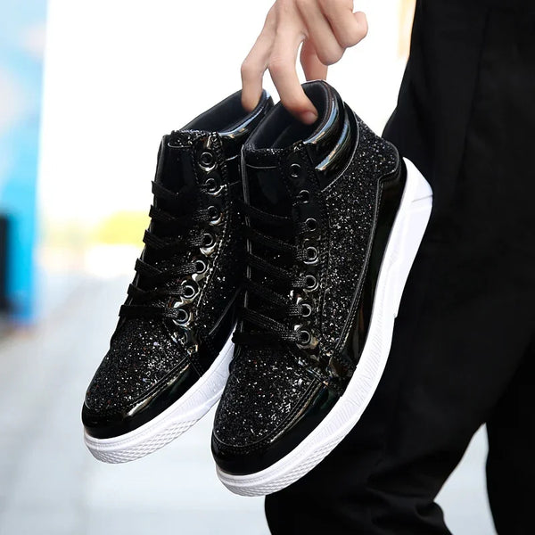 Pair of black glitter high-top sneakers held by their collars, shown from above