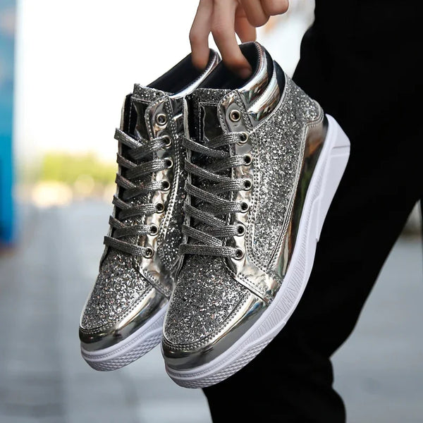 Pair of silver glitter high-top sneakers held by their collars