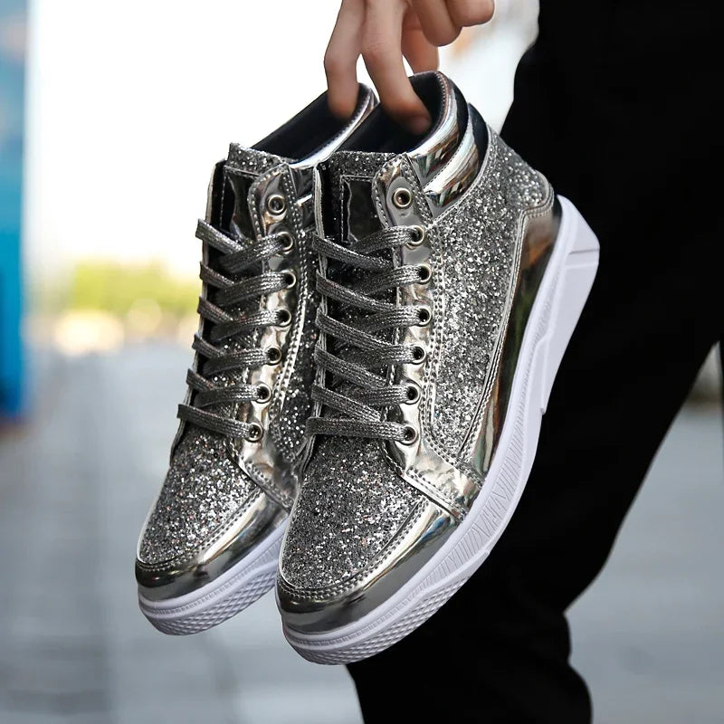 Pair of silver glitter high-top sneakers held by their collars