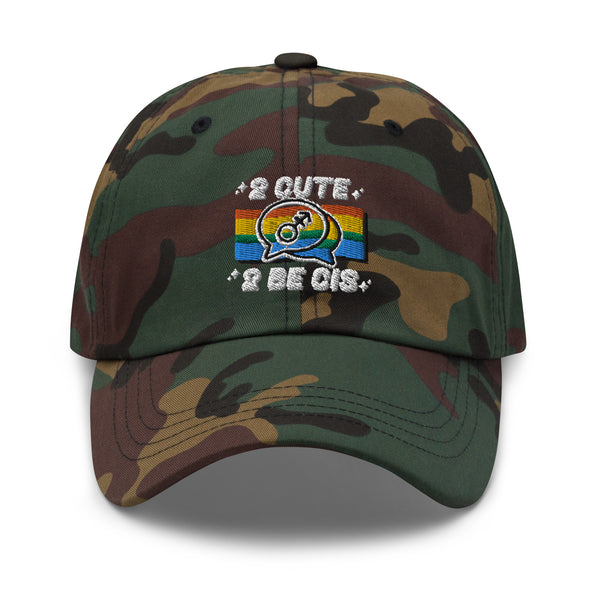 Queer camouflage cap with white “2 CUTE” and “2 BE CIS” embroidery, turtle, sunset, and rainbow waves for bold trans pride.