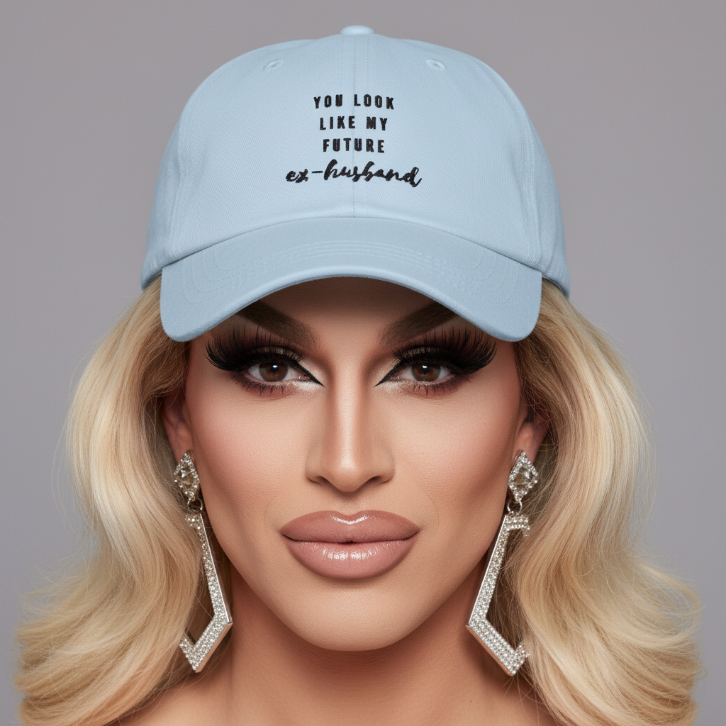 Light blue cap reading “YOU LOOK LIKE MY FUTURE ex-husband,” worn in a close-up portrait