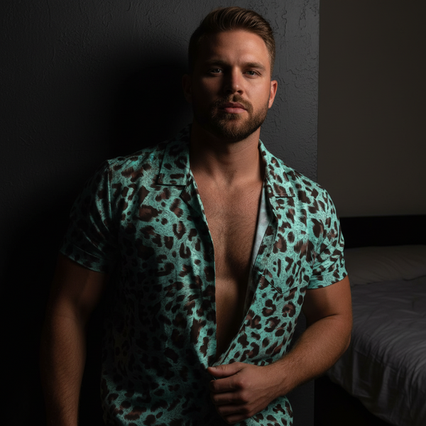 Bearded person models an open teal-and-brown leopard-print short-sleeve shirt