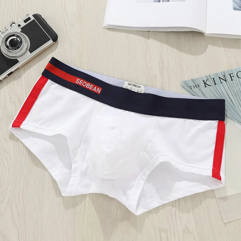 Flat-lay white men's boxer briefs with red side panels and a navy SEOBEAN waistband